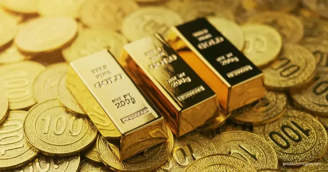 Three 200g fine gold bars resting on a pile of gold coins