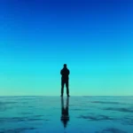 My view of a lone trader silhouetted against a blue horizon, reflecting on my transition to FTMO futures.